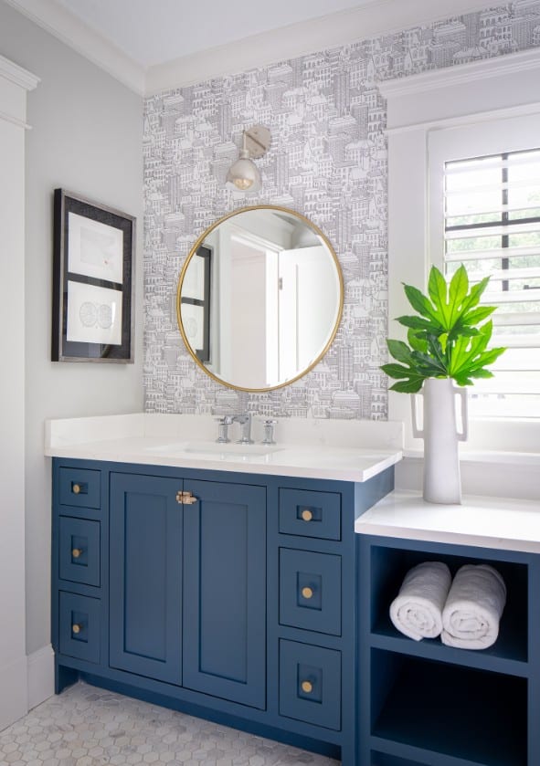 Guest bathroom with blue vanity, gray and white vanity wall tile, and custom built-in shelves.
