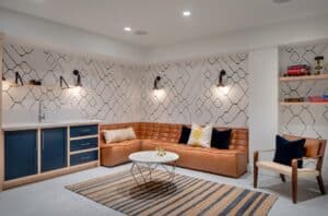 Modern basement playroom with leather couch and black and white patterned wallpaper