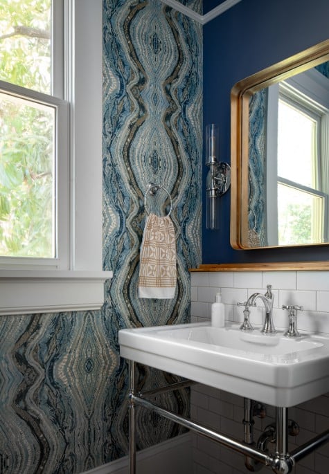 Powder room with bold blue wallpaper.