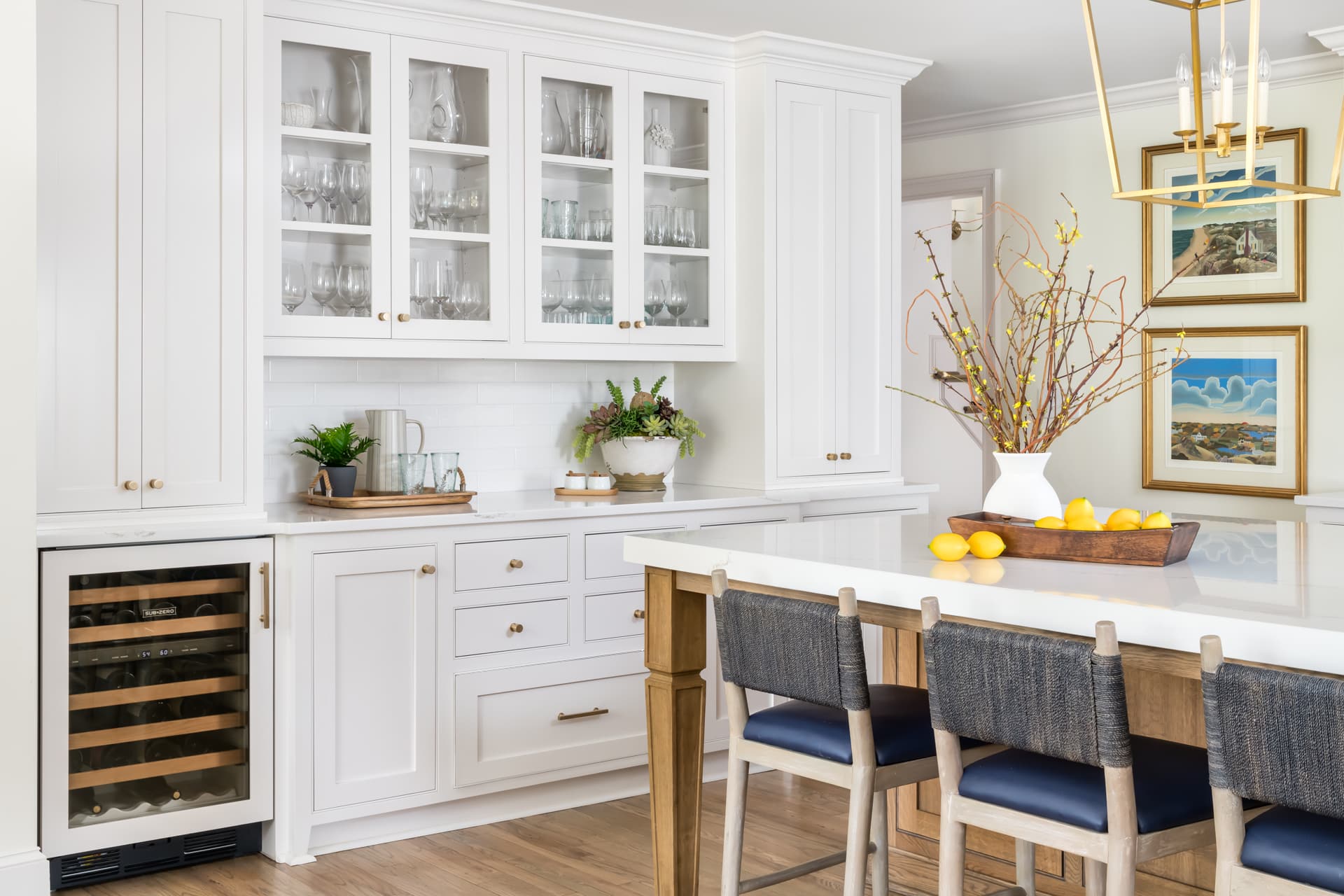 Transitional kitchen with white kitchen buffet, white counters, and glass door upper cabinets.