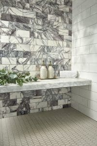 Floating bench with gray and white marble wall tile.