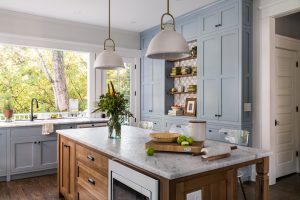 Kitchen with blue cabinetry and pass through window